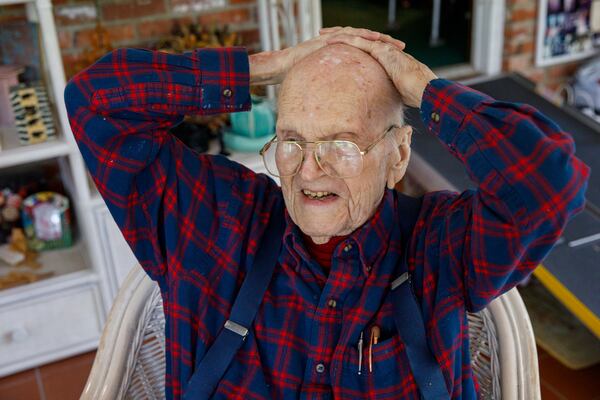 Avery Low, 104, recalls stories from World War II at his home. He was with Gen. George Patton in April 1945 when U.S. troops encountered their first concentration camp at Ohrdruf. (Walker Smith for the AJC)