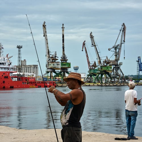 A fisherman prepares his fishing rod in front of the Colombian Navy ship ARC Caribe, docked at a pier in Havana, Cuba, after arriving with humanitarian aid, Friday, June 12, 2926. (AP Photo/Ramon Espinosa)