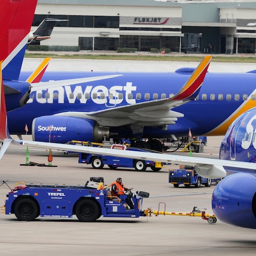Flight line workers push a Southwest Airlines aircraft away from a gate at Love Field Airport in Dallas, Monday, March 16, 2026. (AP Photo/Tony Gutierrez)
