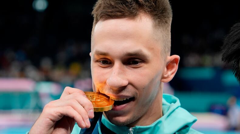 FILE - Ivan Litvinovich of the Individual Neutral Athletes celebrates after winning the gold medal during the men's trampoline finals in Bercy Arena at the 2024 Summer Olympics, Friday, Aug. 2, 2024, in Paris, France. (AP Photo/Charlie Riedel, File)