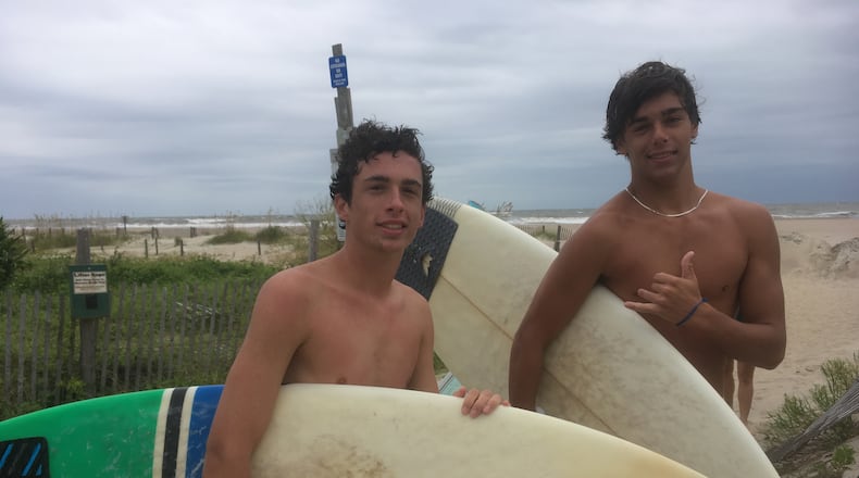 Will Waters, left, and Noah Mosely didn't evacuate Tybee Island. They surfed instead. Photo: Jennifer Brett