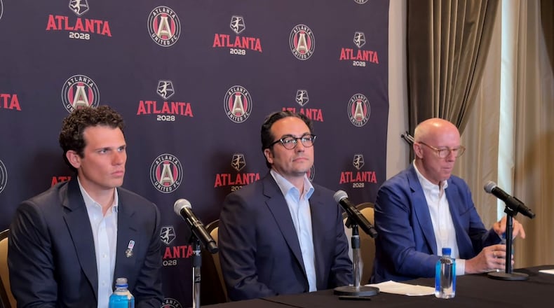 Mauricio Culebro (center), the president of soccer for Atlanta United and the city's upcoming NWSL franchise, answers questions at his introductory press conference. Josh Blank (left), vice president of executive for AMBSE, and Rich McKay (right), CEO of AMBSE, also took part. (Amna Subhan/AJC)