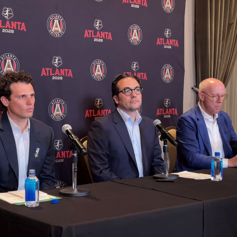 Mauricio Culebro (center), the president of soccer for Atlanta United and the city's upcoming NWSL franchise, answers questions at his introductory press conference. Josh Blank (left), vice president of executive for AMBSE, and Rich McKay (right), CEO of AMBSE, also took part. (Amna Subhan/AJC)