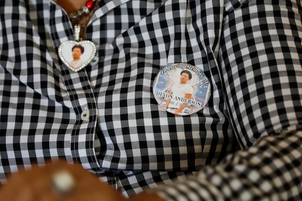 Valerie Lans-Anderson, mother of Devon Anderson, wears a pendant and a pin with her son's image, as seen on Thursday, July 31, 2025.(Miguel Martinez/AJC)