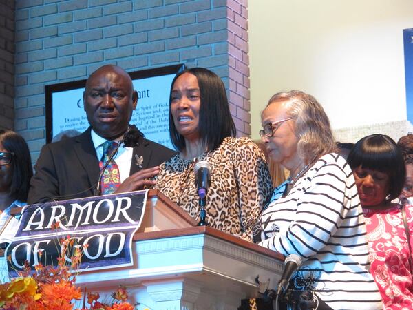 FILE - Regina Brinson, center, weeps at a news conference Tuesday, Oct. 22, 2024, while speaking alongside her mother, Katrena Alexander and attorney Ben Crump during a news conference in Jacksonville, Fla. Crump represents families of three of the seven people killed when a ferry dock walkway collapsed on Sapelo Island, Ga., on Saturday, Oct. 19. (AP Photo/Russ Bynum)