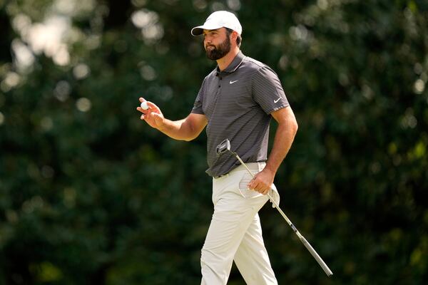 Scottie Scheffler waves after making a putt on the fifth hole during the third round at the Masters golf tournament, Saturday, April 12, 2025, in Augusta, Ga. (AP Photo/Julia Demaree Nikhinson)