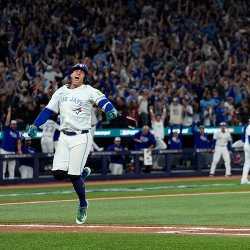 Toronto Blue Jays' George Springer reacts after hitting a three run home run against the Seattle Mariners during the seventh inning in Game 7 of baseball's American League Championship Series, Monday, Oct. 20, 2025, in Toronto. (AP Photo/David J. Phillip)