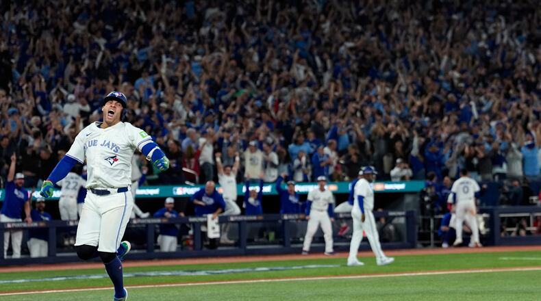 Toronto Blue Jays' George Springer reacts after hitting a three run home run against the Seattle Mariners during the seventh inning in Game 7 of baseball's American League Championship Series, Monday, Oct. 20, 2025, in Toronto. (AP Photo/David J. Phillip)