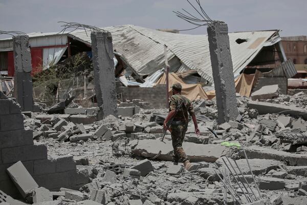 A Yemeni soldier inspects the damage reportedly caused by U.S. airstrikes in Sanaa, Yemen, Sunday, April 27, 2025. (AP Photo/Osamah Abdulrahman)