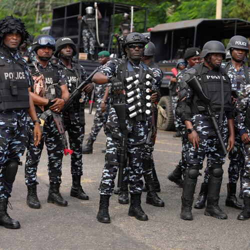 FILE - Nigeria police officers stand guard during a candle light procession in honour of all protesters killed nationwide at the recently economic hardship protest, in Lagos, Nigeria, Friday, Aug. 9, 2024. (AP Photo/Sunday Alamba, file)