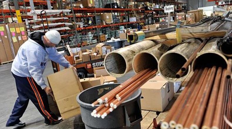 Worker at a HD Supply distribution center. The Atlanta-based company, once a part of Home Depot, has a deal to merge once again back into the home improvement giant.