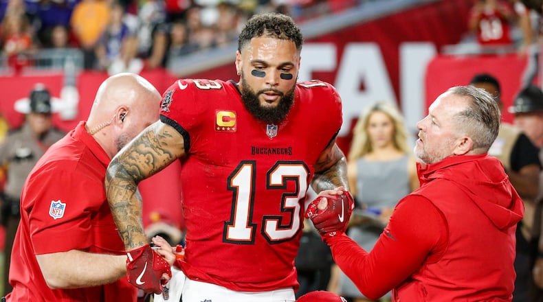 Bucs wide receiver Mike Evans (13) is helped by medical staff during the second quarter. He did not return. (Jefferee Woo/Tampa Bay Times/TNS)