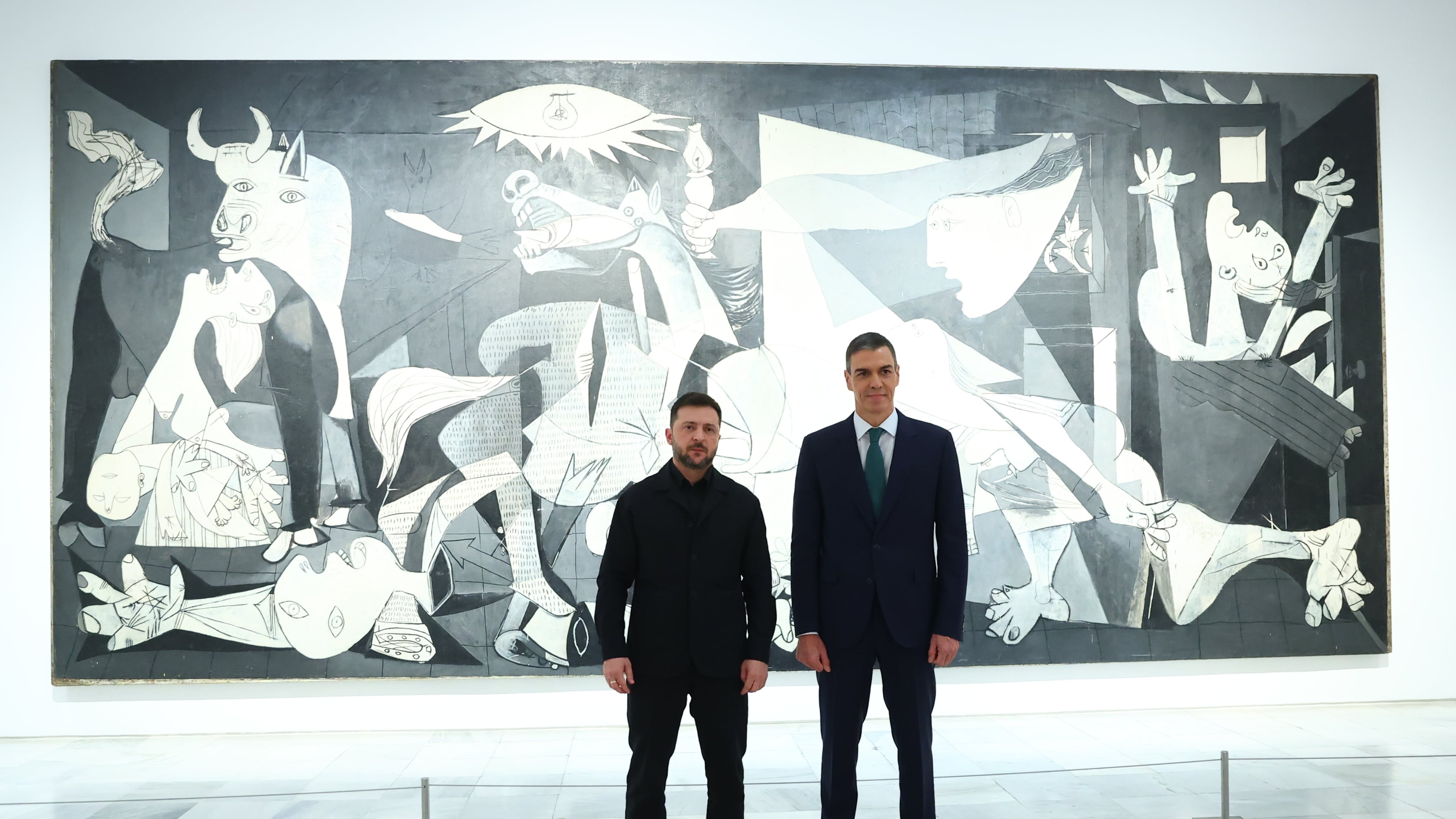 In this photo provided by the Spanish government, Ukrainian President Volodymyr Zelenskyy poses with Spain's Prime Minister Pedro Sánchez in front of Pablo Picasso's "Guernica" in Madrid Tuesday, Nov. 18, 2025. (Spanish government via AP)