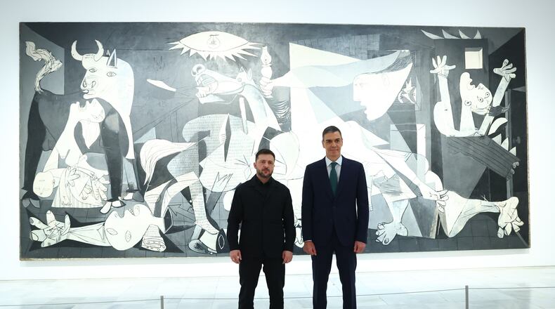 In this photo provided by the Spanish government, Ukrainian President Volodymyr Zelenskyy poses with Spain's Prime Minister Pedro Sánchez in front of Pablo Picasso's "Guernica" in Madrid Tuesday, Nov. 18, 2025. (Spanish government via AP)