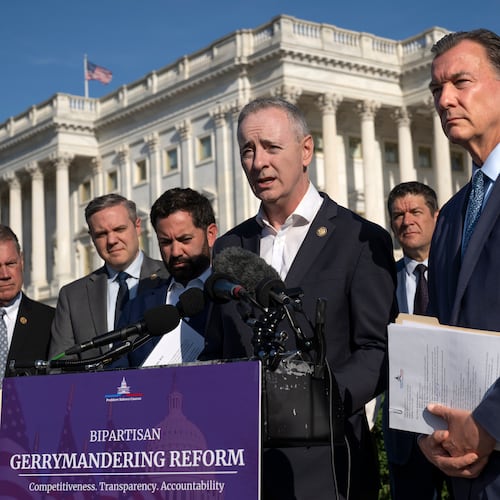 Rep. Brian Fitzpatrick, R-Pa., center, and Rep. Tom Suozzi, D-N.Y., right, talk to reporters about partisan gerrymandering, the reshaping of congressional districts to benefit one political party, during a news conference at the Capitol in Washington, Wednesday, Sept. 16, 2026. (AP Photo/J. Scott Applewhite)