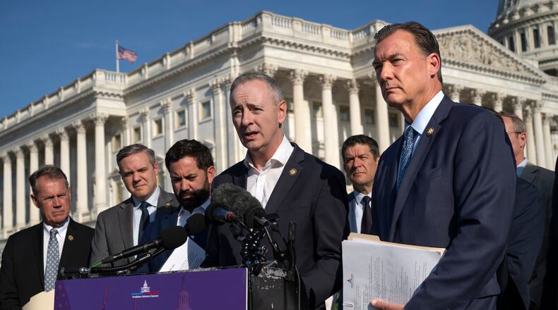 Rep. Brian Fitzpatrick, R-Pa., center, and Rep. Tom Suozzi, D-N.Y., right, talk to reporters about partisan gerrymandering, the reshaping of congressional districts to benefit one political party, during a news conference at the Capitol in Washington, Wednesday, Sept. 16, 2026. (AP Photo/J. Scott Applewhite)