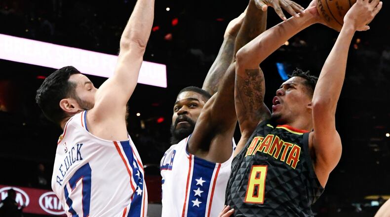 Hawks guard Damion Lee (8) shoots as Philadelphia 76ers guard JJ Redick (17) and center Amir Johnson defend during the first half of an NBA basketball game Tuesday, April 10, 2018, in Atlanta. (AP Photo/John Amis)