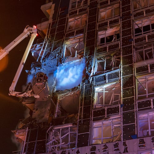 Emergency services personnel work to extinguish a fire following a Russian attack in Kyiv, Ukraine, Tuesday, Nov. 25, 2025. (AP Photo/Dan Bashakov)