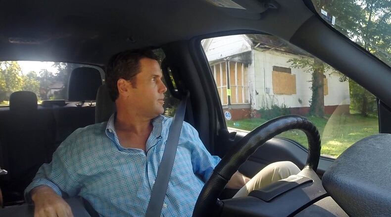 Businessman Rick Warren drives through the English Avenue neighborhood where companies he controls own at least 150 properties. That amounts to about 10 percent of its residential properties, what may be an unprecedented amount for a major city, experts said. BOB ANDRES / BANDRES@AJC.COM