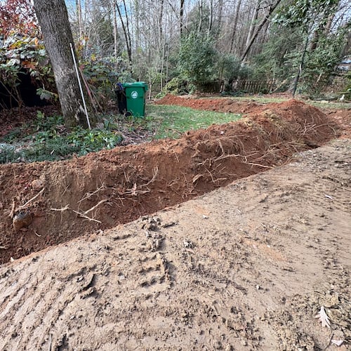 This trench has severely encroached on the critical root zone of this tree. The curving around the tree exacerbates the damage. The tree will suffer as a result. (Courtesy of Matt Davidson)