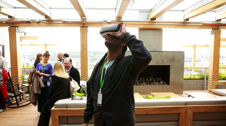 FILE: A visitor tries on a virtual-reality headset at Facebook’s Seattle offices in 2017. (Erika Schultz/Seattle Times/TNS)