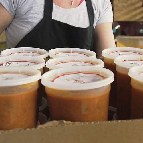 November 30, 2018 Atlanta - Amanda Marmins, a volunteer at Souper Jenny, finishes the preparation for one box of soup that will help feed kids in the metro area. RYON HORNE / RHORNE@AJC.COM