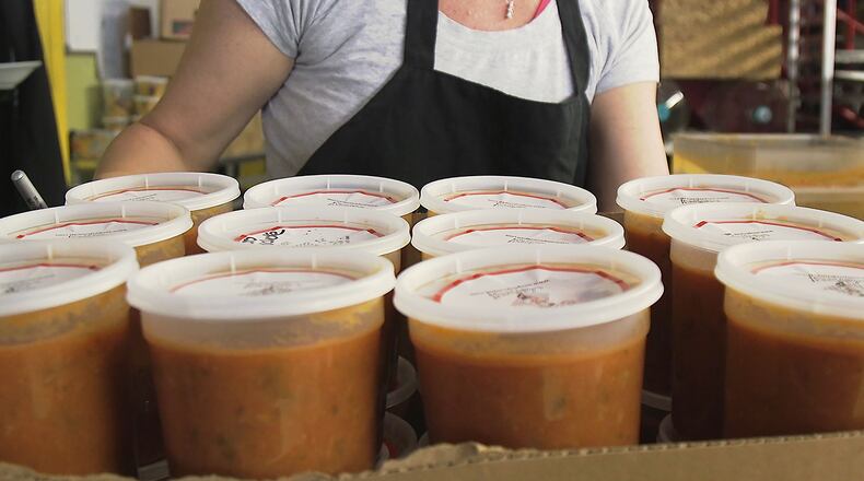 November 30, 2018 Atlanta - Amanda Marmins, a volunteer at Souper Jenny, finishes the preparation for one box of soup that will help feed kids in the metro area. RYON HORNE / RHORNE@AJC.COM