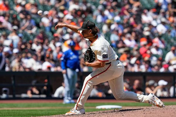 San Francisco Giants pitcher Jordan Hicks throws to a Kansas City Royals batter during the eighth inning of a baseball game Wednesday, May 21, 2025, in San Francisco. (AP Photo/Godofredo A. Vásquez)
