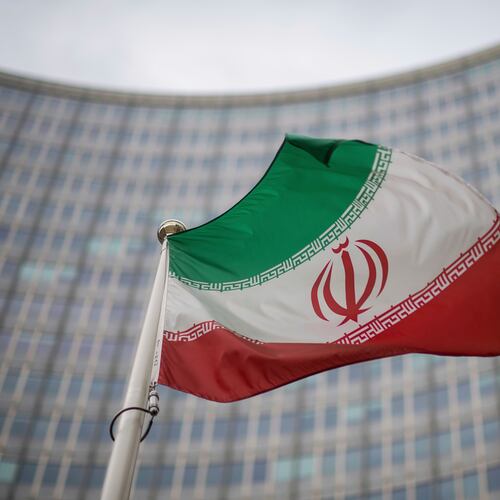 FILE -A national flag of Iran waves in front of the building of the International Atomic Energy Agency, IAEA, in Vienna, Austria, Dec. 17, 2021. (AP Photo/Michael Gruber, File)