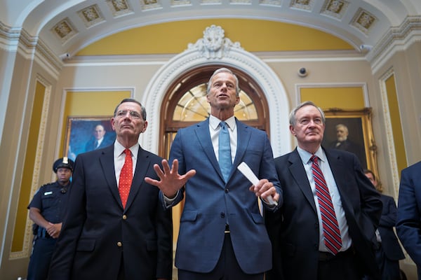 Senate Majority Leader John Thune, R-S.D., is flanked by Sen. John Barrasso, R-Wyo., the GOP whip, left, and Finance Committee Chairman Mike Crapo, R-Idaho, speaks to reporters after passage of the budget reconciliation package of President Donald Trump's signature bill of big tax breaks and spending cuts, at the Capitol in Washington, Tuesday, July 1, 2025. (AP Photo/J. Scott Applewhite)