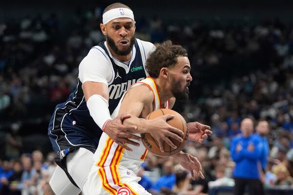 Atlanta Hawks guard Trae Young, right, is fouled by Dallas Mavericks center Daniel Gafford during the first half of an NBA basketball game in Dallas, Wednesday, April 2, 2025. (AP Photo/LM Otero)