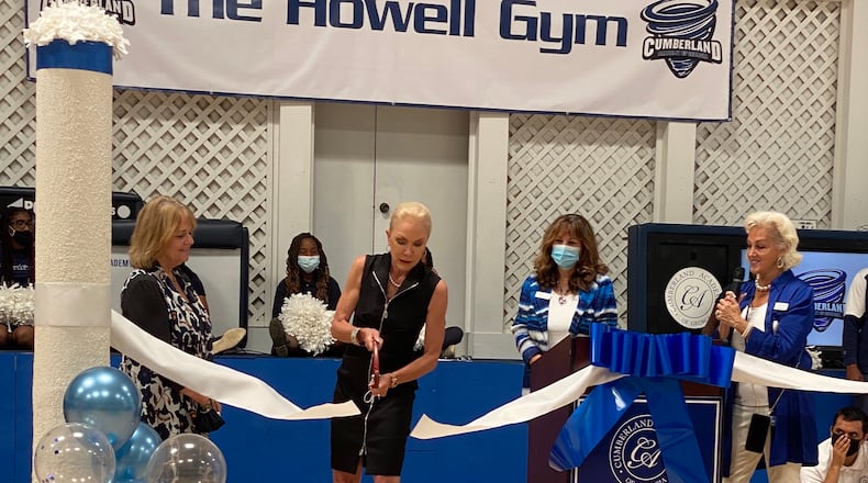 Robin Howell cuts the ribbon at the newly renovated Cumberland gymnasium as Sandy Springs First Lady and Leadership SS Executive Director Jan Paul (L), Cheerleader Jordan Campbell (back), Cumberland Assistant Headmaster Dr. Kathy Meskell, and Founder and Headmaster Debbi Scarborough look on. (Courtesy Cumberland Academy)