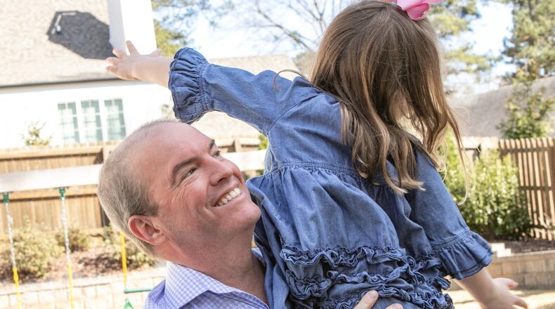 Steve Chesley is home again playing in the backyard with his youngest daughter earlier this month. Steve is immunocompromised and received leukemia treatment during the pandemic, so he spent several months in an AirBnb away from his family, to minimize chances of infection. (Jenni Girtman for The Atlanta Journal-Constitution)
