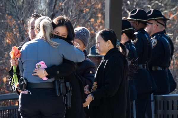 People hug before the celebration of life for Gwinnett police officer Pradeep Tamang at 12Stone Church on Saturday, Feb. 7, 2026, in Lawrenceville. (Ben Gray for the AJC)