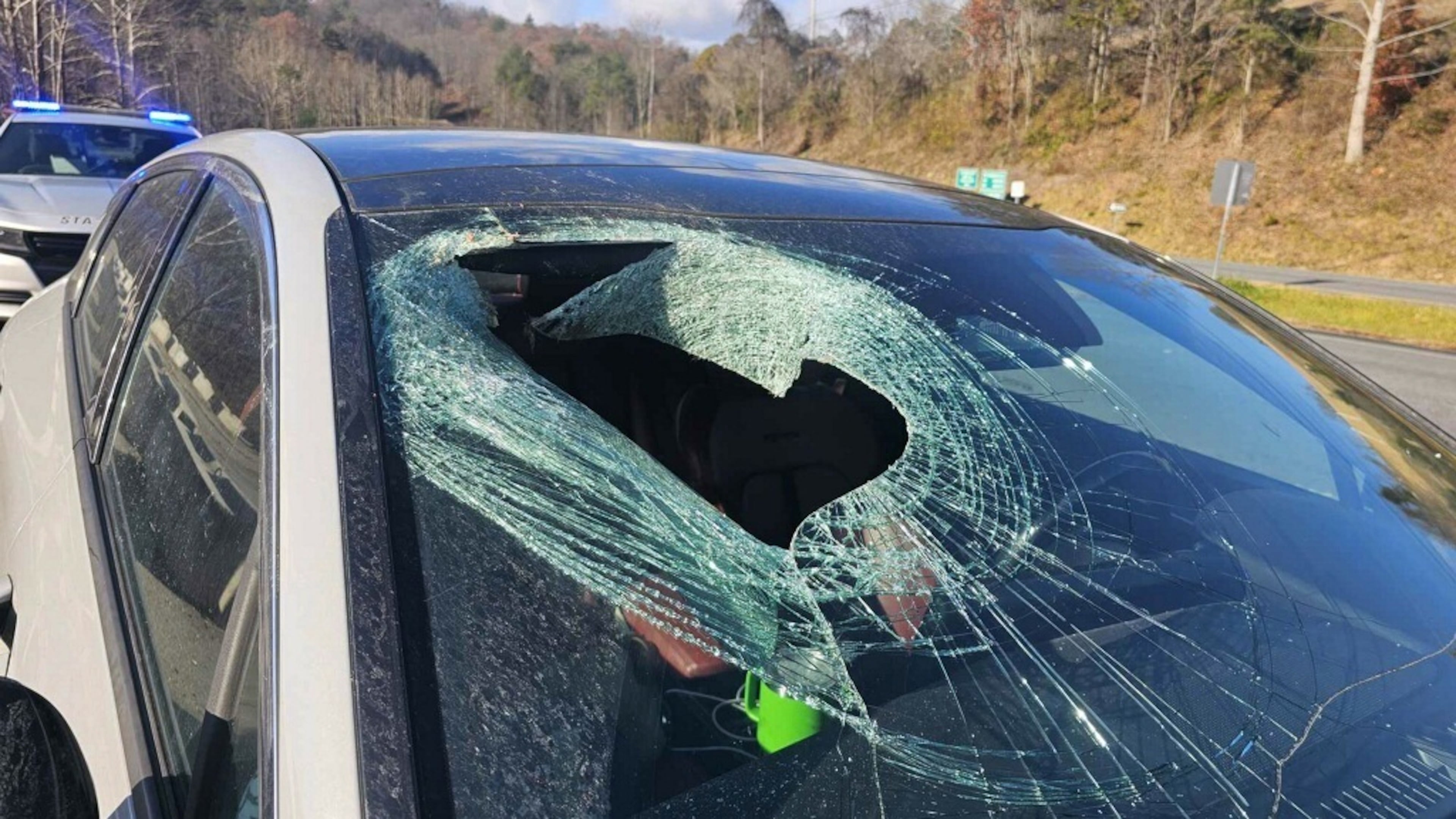 This photo provided by N. C. State Highway Patrol Public Information Office shows a smashed windshield after a cat carcass crashed into the car along a highway near the Great Smoky Mountains National Park in North Carolina on Wednesday, Nov. 19, 2025. (N. C. State Highway Patrol Public Information Office via AP)