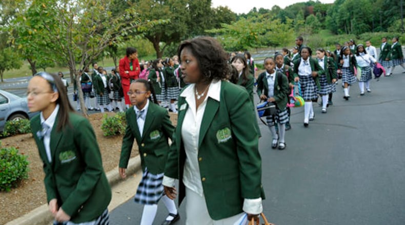 Ivy Prep's founder, Nina Gilbert (right), has reengaged with the school after pursuring other projects for a few years. Ivy Prep closed its Gwinnett County campus, surprising parents and students. In this photo, from 10 years ago, Gilbert and Ivy Prep  students were walking  to Gwinnett County Public Schools Instructional Support Center to protest a lawsuit Gwinnett Schools filed against them.