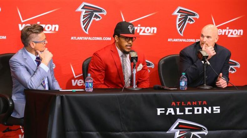 Falcons General Manager Thomas Dimitroff (left) and head coach Dan Quinn look on as first-round draft pick Vic Beasley takes questions from the media during his press conference at the Falcons training facility on Friday, May 1, 2015, in Flowery Branch. Beasley, who was the 8th overall pick in the NFL draft, is Clemson's sack leader. Curtis Compton / ccompton@ajc.com