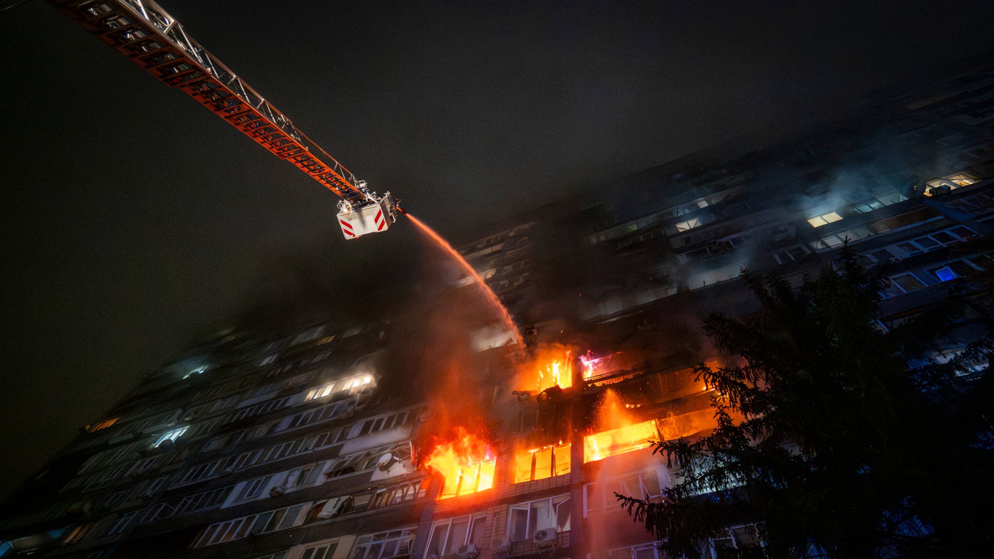 Emergency services personnel work to extinguish a fire following a Russian attack in Kyiv, Ukraine, Friday, Oct. 10, 2025. (AP Photo/Dan Bashakov)