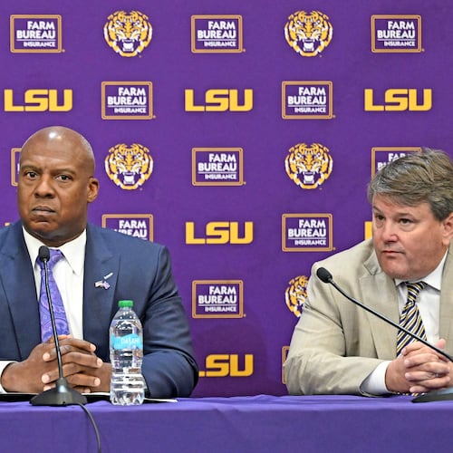 LSU board of supervisors member, from left, John H. Carmouche speaks alongside LSU interim athletic director Verge Ausberry and LSU board of supervisors chair Scott Ballard during a press conference to discuss the change in the LSU athletic department leadership, Friday, Oct. 31, 2025, in Baton Rouge, La. (Hilary Scheinuk/The Advocate via AP)
