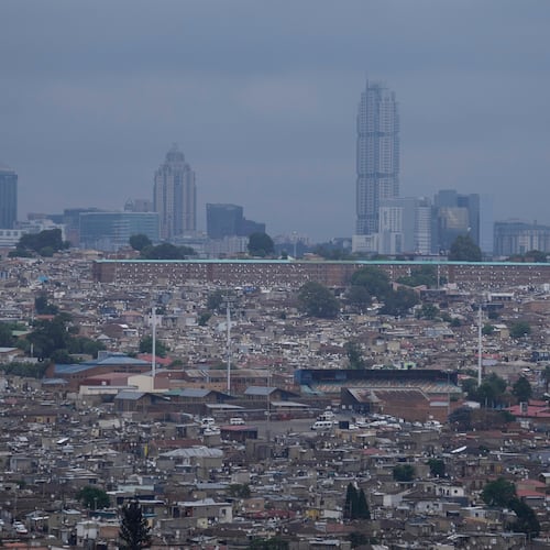 A view of Alexandra township, with the Sandton financial district in the background, in Johannesburg, South Africa, Friday, Nov. 14, 2025. (AP Photo/Themba Hadebe)