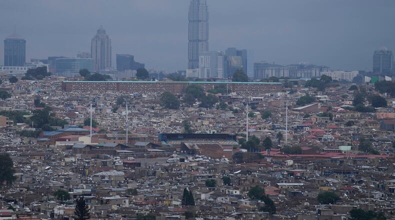 A view of Alexandra township, with the Sandton financial district in the background, in Johannesburg, South Africa, Friday, Nov. 14, 2025. (AP Photo/Themba Hadebe)