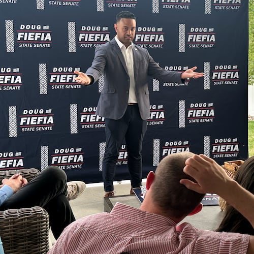 Utah State Rep. Doug Fiefia talks to Utah voters on the back deck of a house, Thursday, April 9, 2026, in Riverton, Utah. Fiefia, a Republican, has a background in technology and is running for the state senate with a pledge to tackle AI. (AP Photo/Nicholas Riccardi)