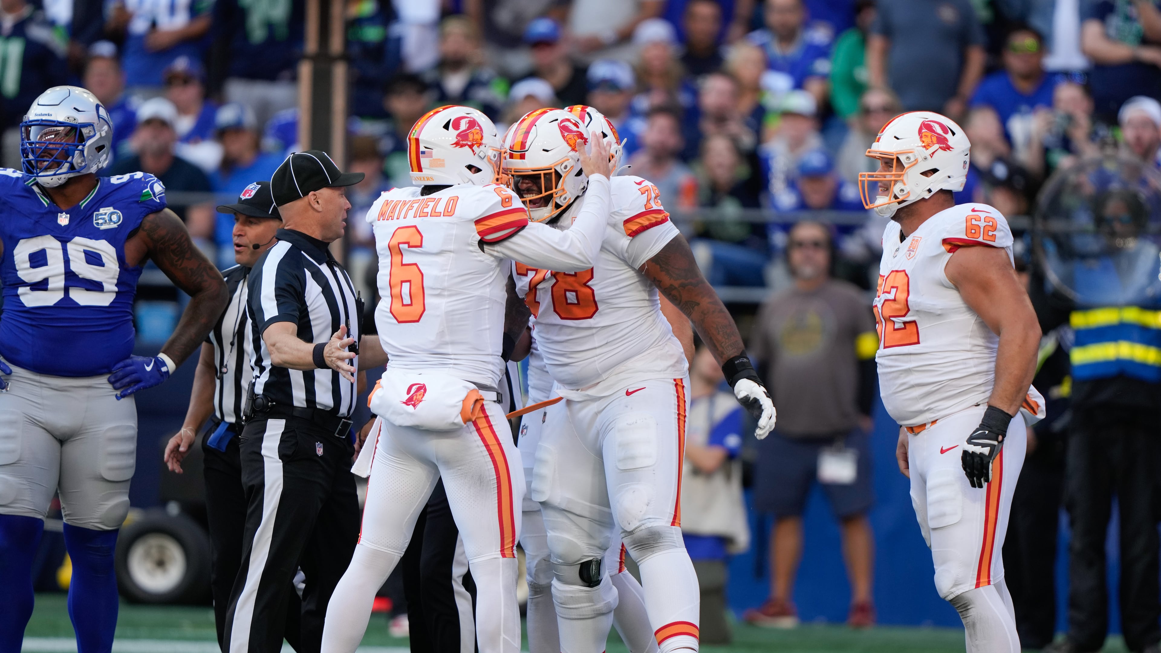 Tampa Bay Buccaneers quarterback Baker Mayfield (6) and offensive tackle Tristan Wirfs (78) celebrate after a penalty was called on the Seattle Seahawks during the second half of an NFL football game Sunday, Oct. 5, 2025, in Seattle. (AP Photo/Stephen Brashear)