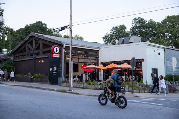 A resident rides a bike by Fritti's at Inman Park. (Brandon McKeown/Access Atlanta 2022)