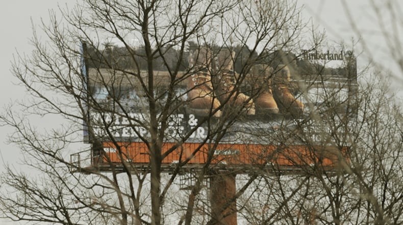 A new law that allows billboard owners to clear-cut trees that block their signs is caught in legal wrangling.