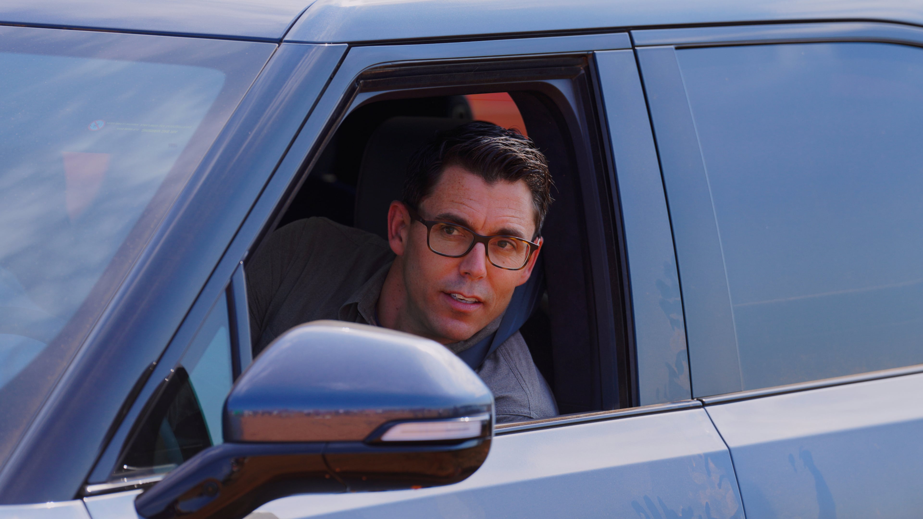 Rivian founder and CEO RJ Scaringe looks out the window of a Rivian R1S after a groundbreaking ceremony at the electric vehicle's future plant outside of Social Circle, Ga, Tuesday, Sept. 16, 2025. (Matthew Pearson/WABE via AP)