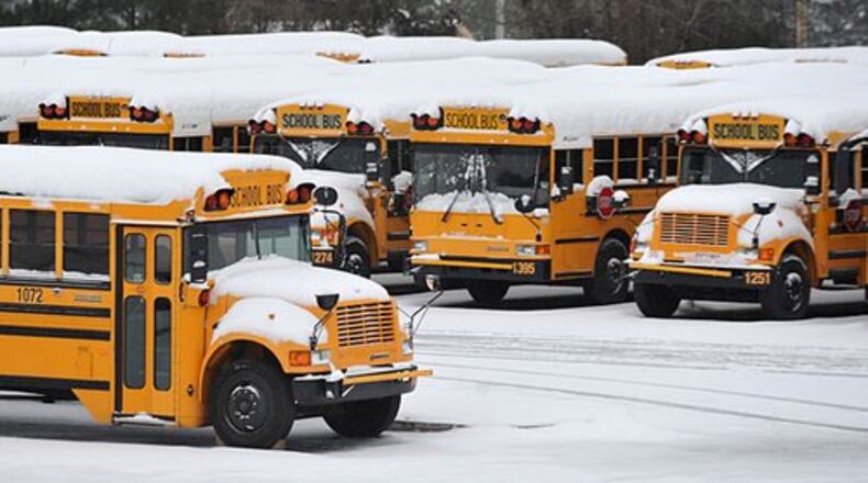 Snow-covered Cobb County school buses remained parked Monday morning, January 10, 2011.