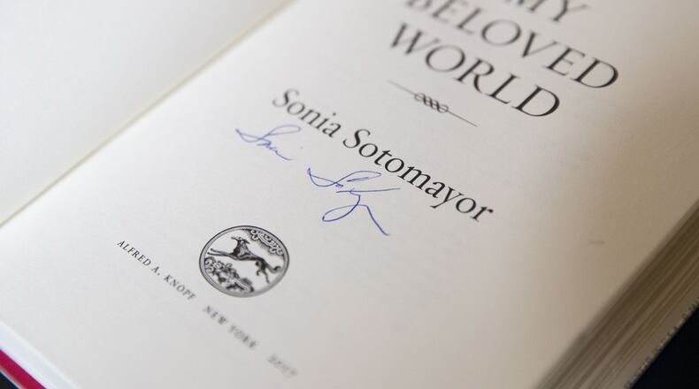 A signed copy of “My Beloved World,” by United States Supreme Court Justice Sonia Sotomayor, is purchased before she speaks with Emory University law professor Fred Smith Jr. at Emory University’s Glenn Memorial Auditorium, Tuesday, Feb. 6, 2018. ALYSSA POINTER/ALYSSA.POINTER@AJC.COM