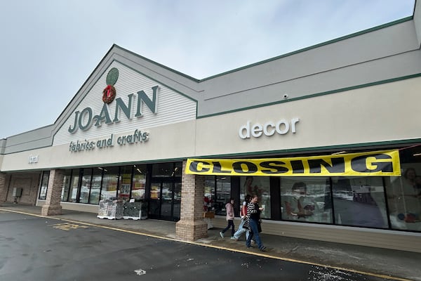 People exit a Joann Fabric and Crafts store in Barre, Vt., on Saturday, March 8, 2025. (AP Photo/Carolyn Lessard)