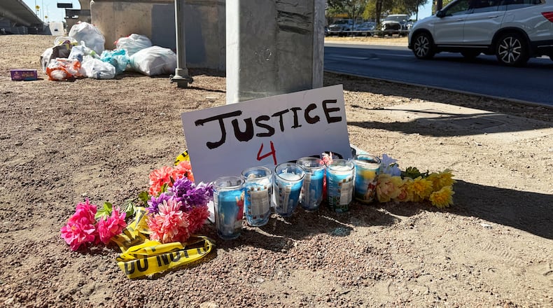 Flowers and candles are placed, Monday, Sept. 21, 2026, near the site where an ICE officer shot a Venezuelan man during a traffic stop the day before, in Austin, Texas. (AP Photo/Jesse Bedayn)